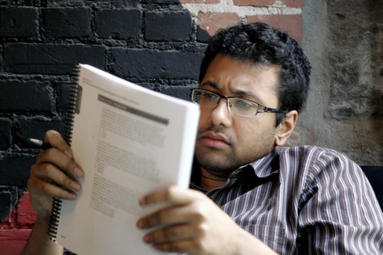 a man sitting with a book in his hand