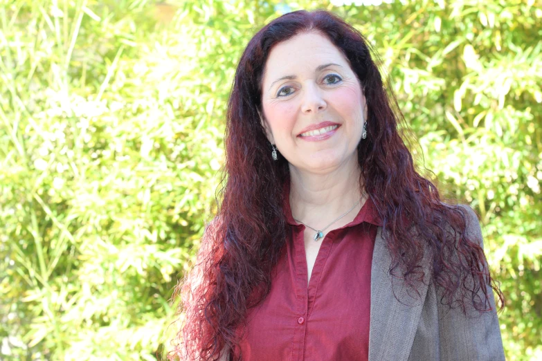 a woman with long hair and maroon shirt