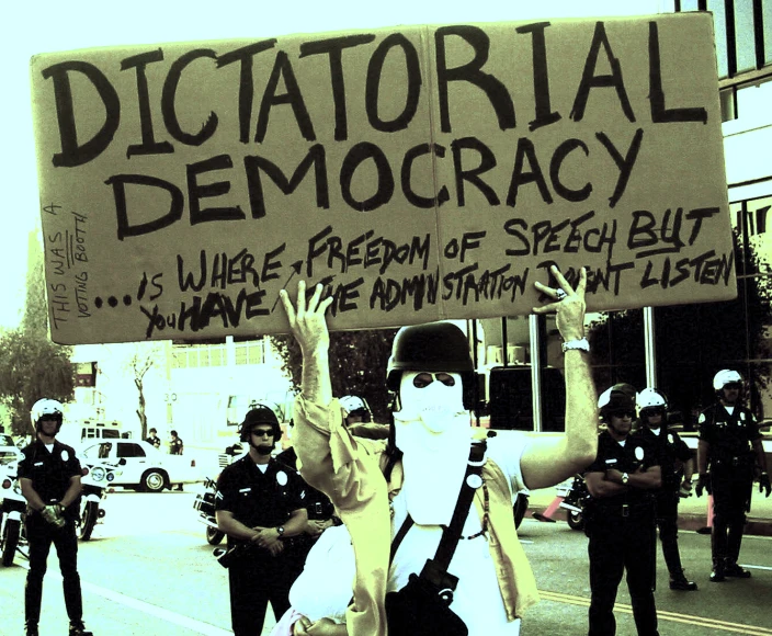 a protestor with a large sign on the street