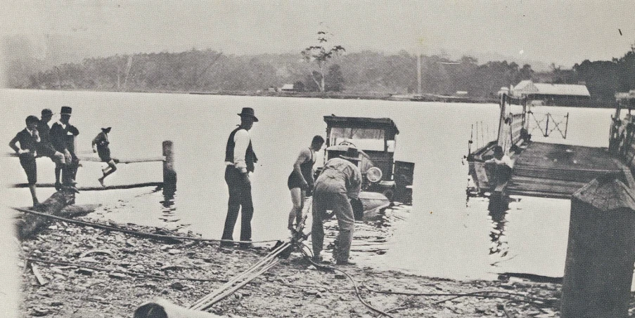 a black and white pograph of people on a boat