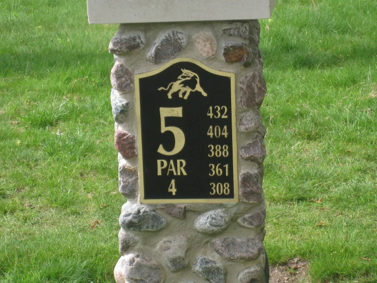 the number five plaque sits in front of a stone structure