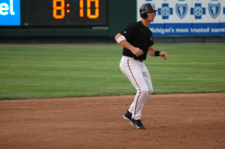 the man runs toward first base after hitting the ball