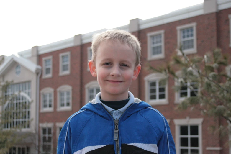 a close up of a person wearing a jacket and a building