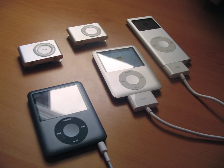 three ipod's connected to each other sitting on a table