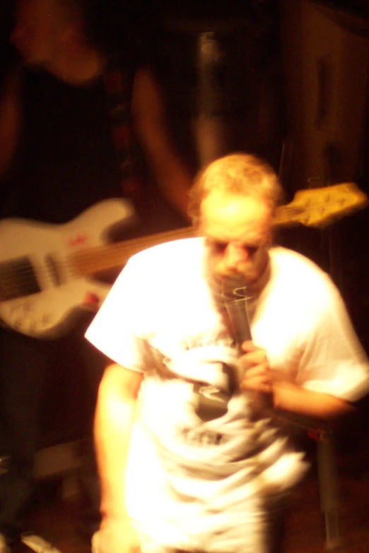 a man talking into a microphone next to a table