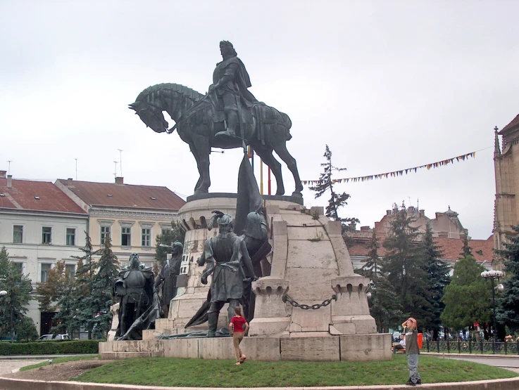 a statue in front of an old european town