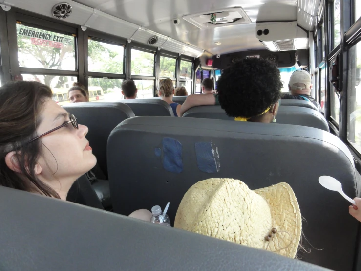 people sitting on a bus looking out the windows