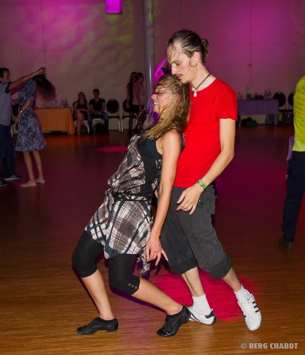 two s dance together in a gymnasium