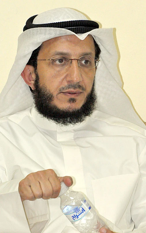 a man in an arab dress points his finger to a bottled bottle