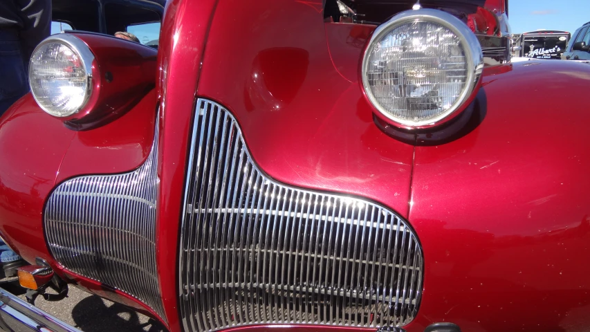 a close up of the headlights and grills on an old fashioned car