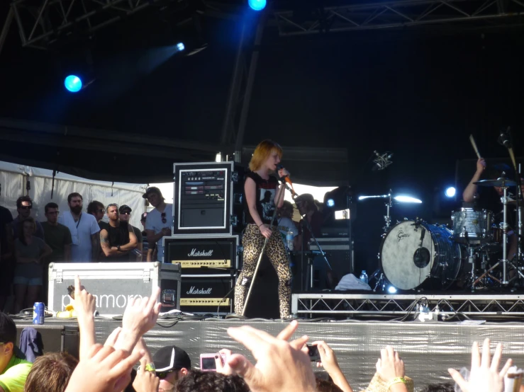 a group of people watching a band on stage