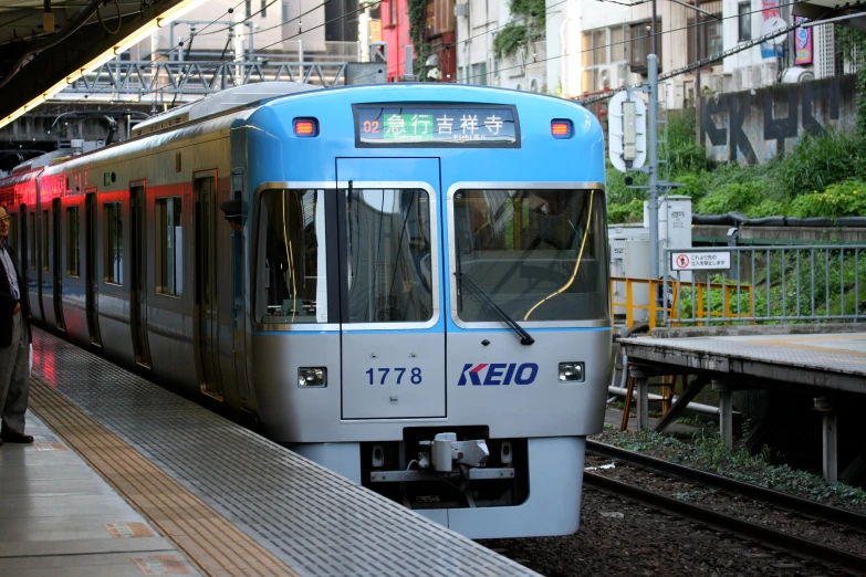 a train on tracks in front of a platform