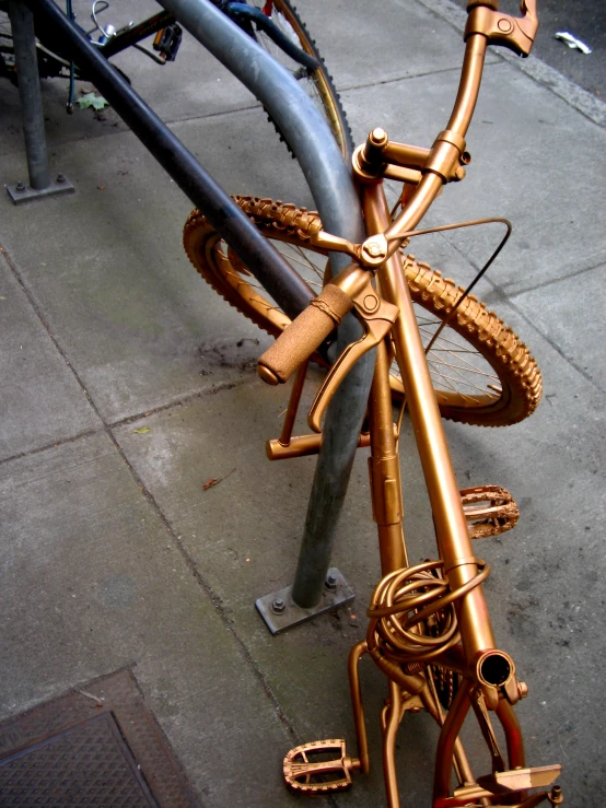 many bikes locked together on the ground with no one around them