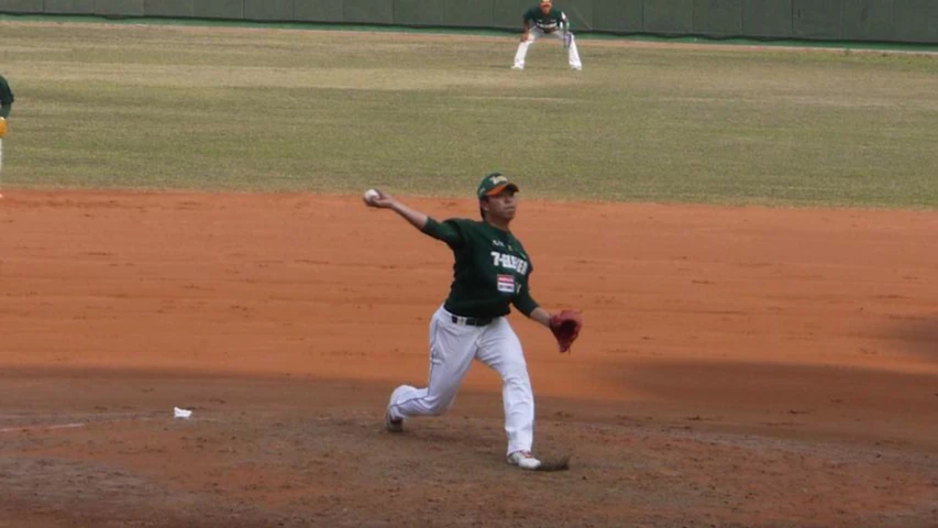 the baseball player is winding up for the next pitch