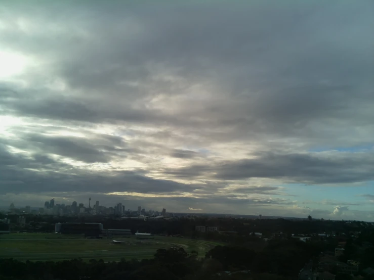 storm clouds in a city skyline with a blue sky