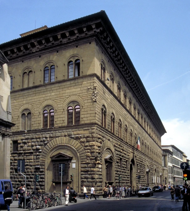 several people walking across the street next to a building