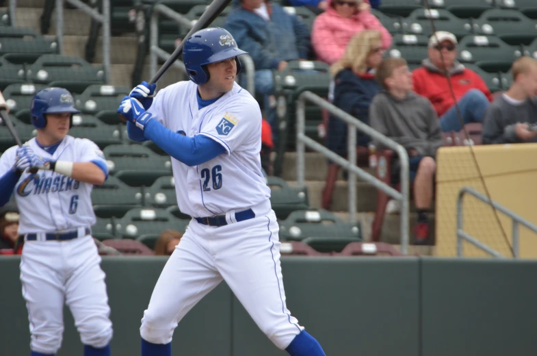 a baseball player is holding a bat and ready for the pitch