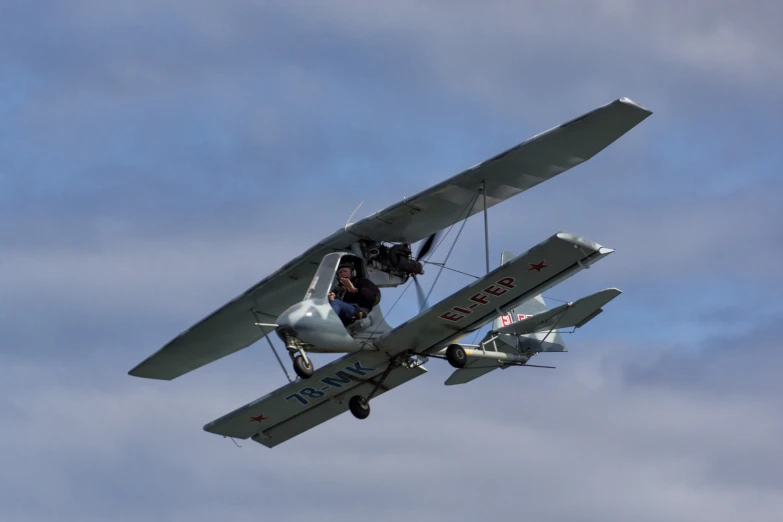 a person hanging from a plane in the air