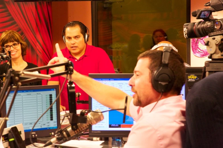 two men in a radio studio with headsets and microphones