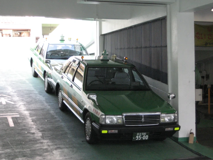 a green vehicle is parked in the middle of a tunnel