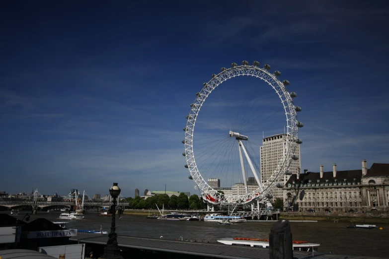 a large ferris wheel sits high above a body of water