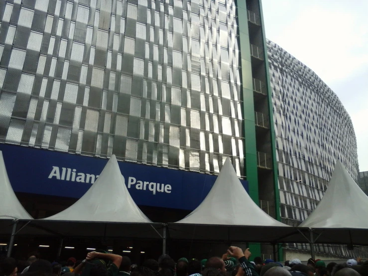 several tented tents at a rally with people watching