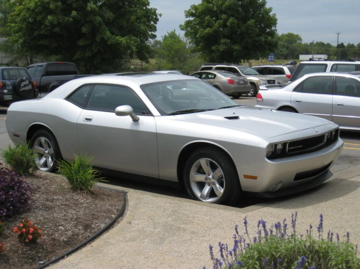 this sports car is parked on the side of a parking lot