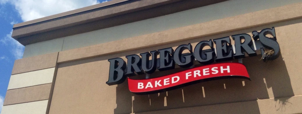 a sign above the bakery's baked fresh sign for bread