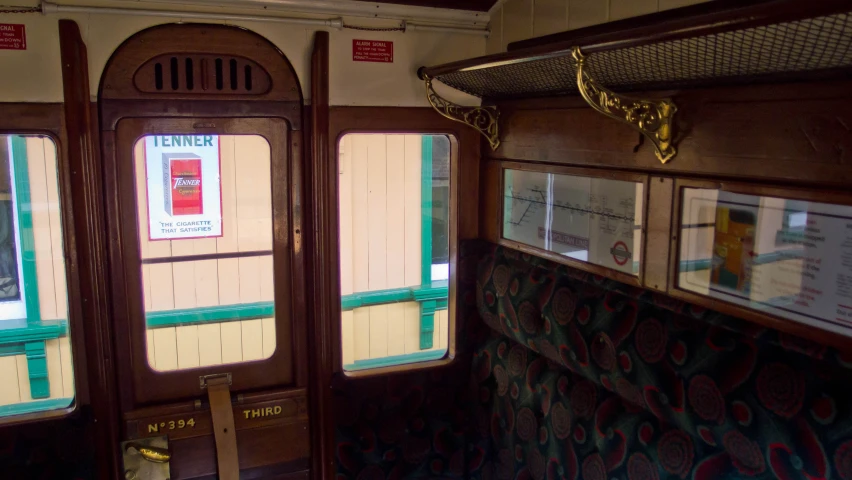 a train carriage with three windows and a few signs