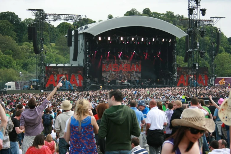 a large group of people are gathered around at a concert