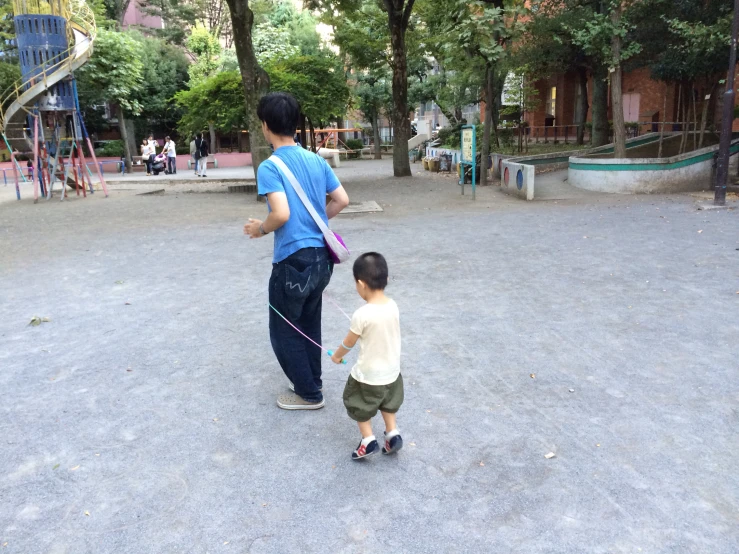 two boys are standing outside in the park
