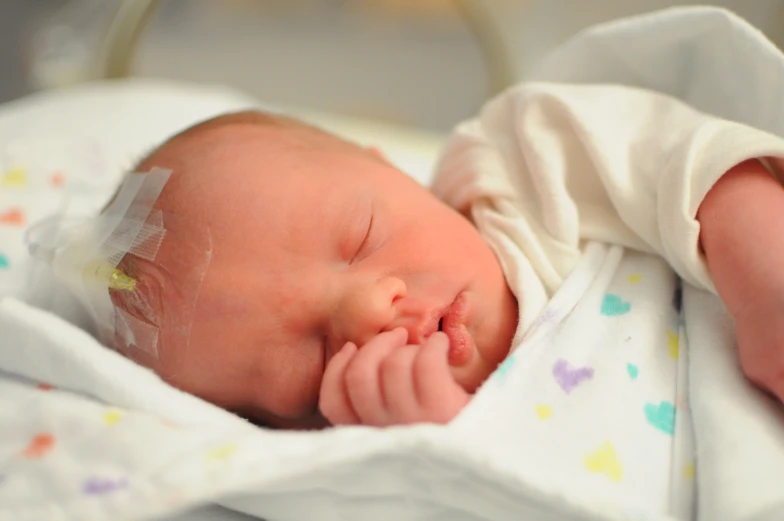 a baby that is laying down on a bed