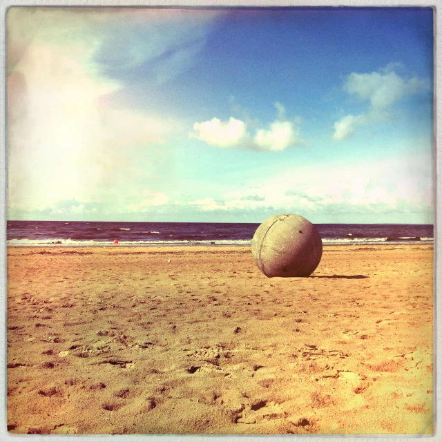 a large round object in the sand on the beach