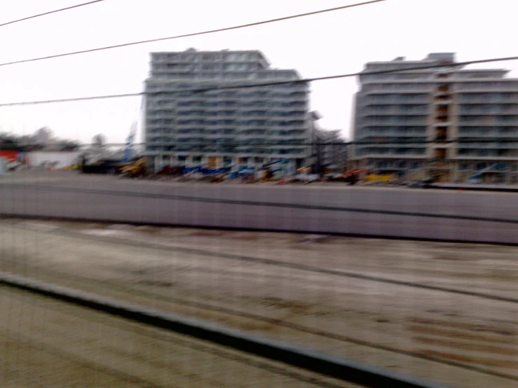 a train traveling through the middle of two tall buildings