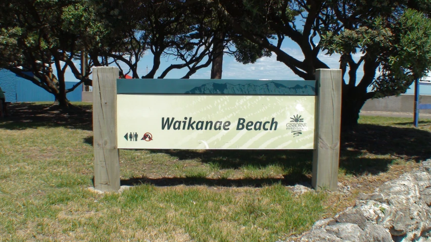 a welcome sign sits in a park setting
