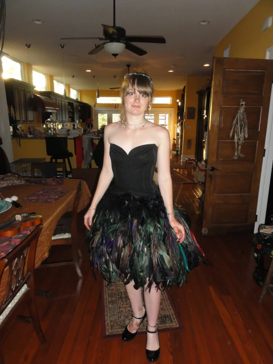 a lady in a dress that has feathers all over it
