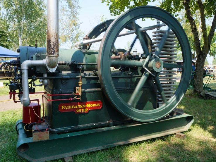 an old machine on display in the grass