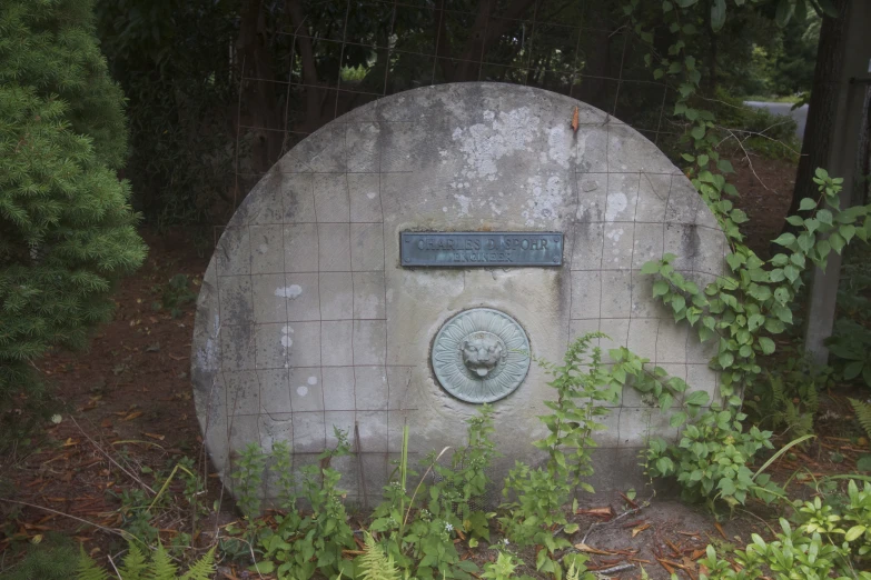 a stone plaque sits on a cement base