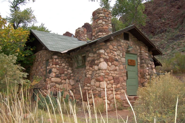 a small building made of rocks in the desert