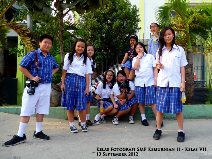 young students pose for a picture with one another in the playground