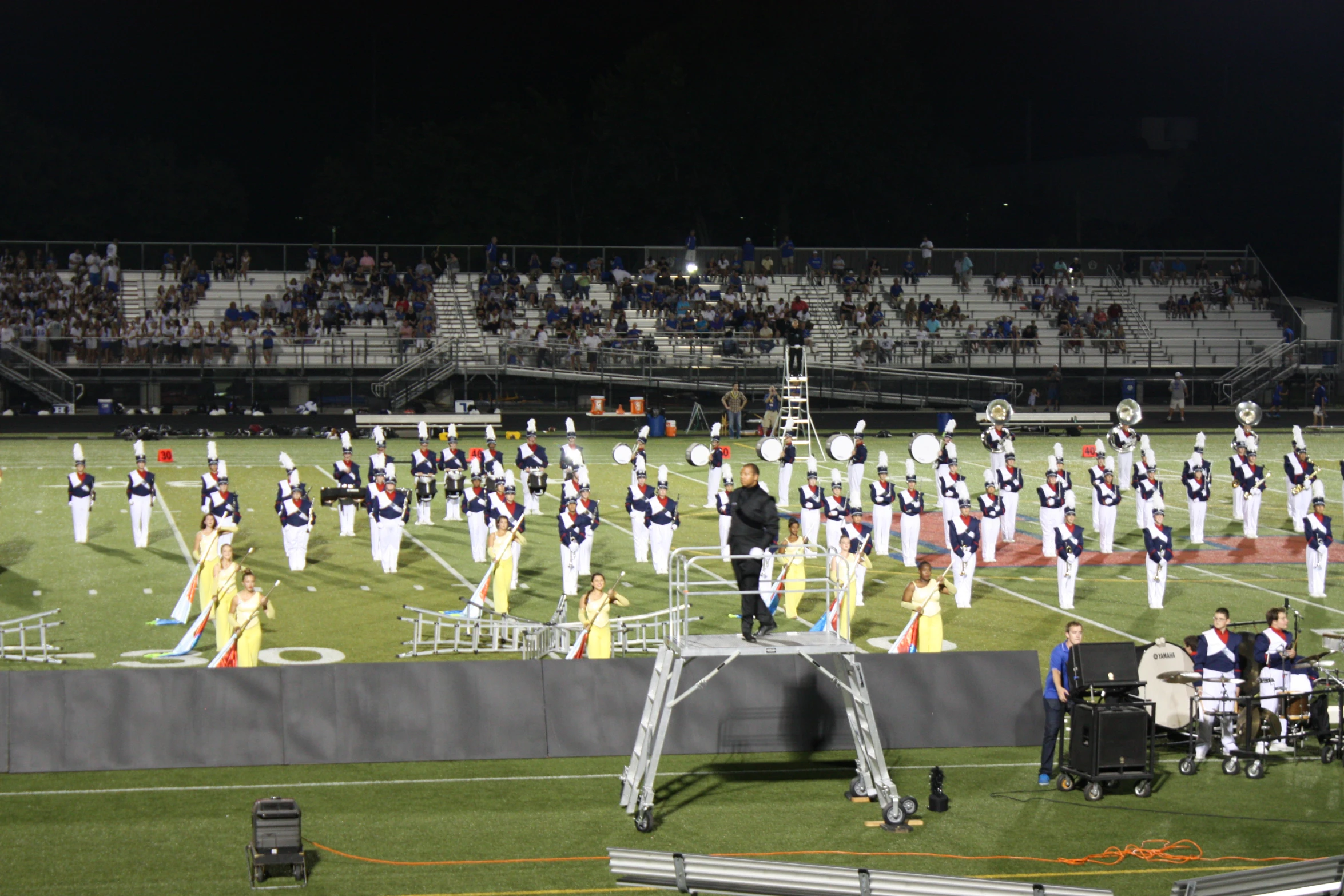 a marching team at the sidelines of an empty stadium