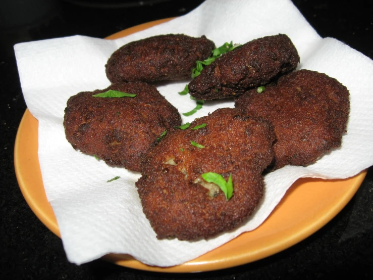 a plate topped with four little bites of meat