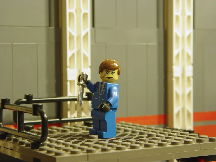 a lego man is holding an iron bar in the background
