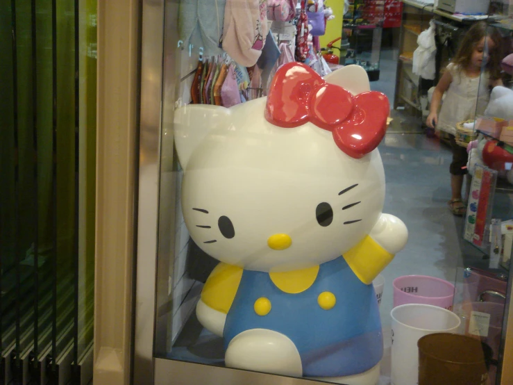 a hello kitty piggy bank inside of a store