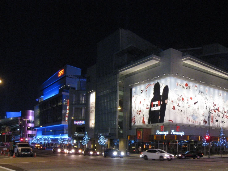 an empty street that has a giant picture projected on the building