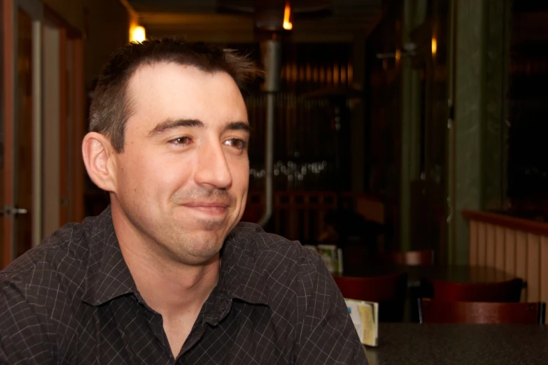 a man sitting in front of a table with a plate of food