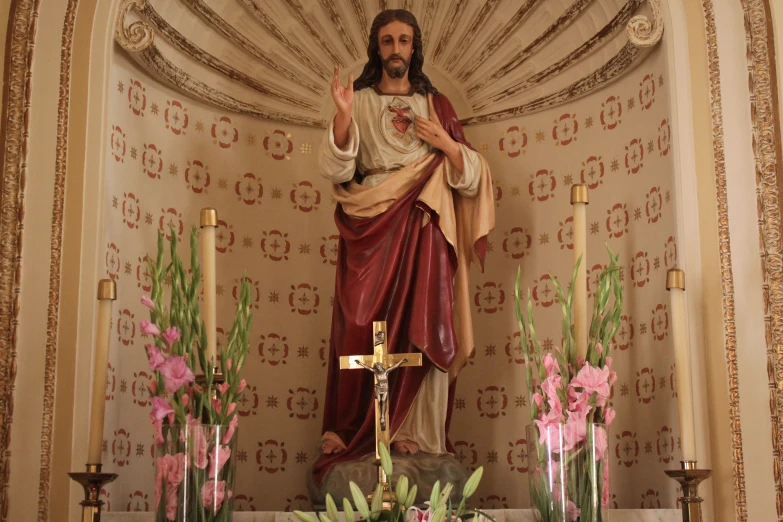 a statue of the christ hanging from a cross