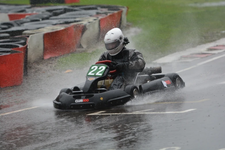 the person on a go kart is being pulled through the rain