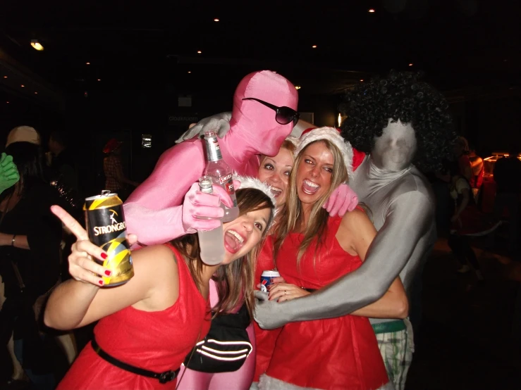 a group of women pose together in costume for a po