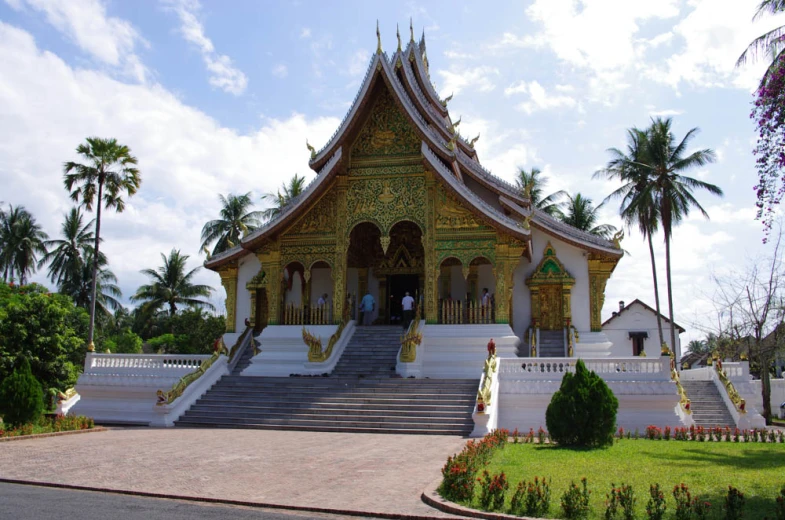 this large gold and white building has steps leading up to it